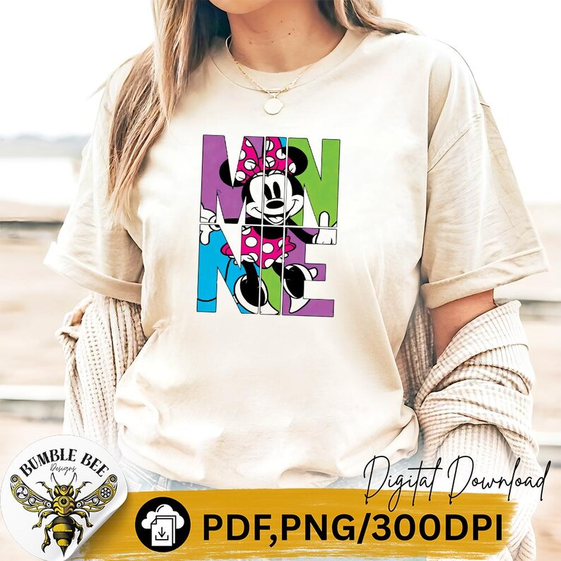 May include: Cream-colored t-shirt featuring a colorful Minnie Mouse graphic. The word "MINNIE" is spelled out in block letters, with Minnie Mouse's image integrated into the design. The shirt also has the words "Digital Download" and "PDF, PNG/300DPI".
