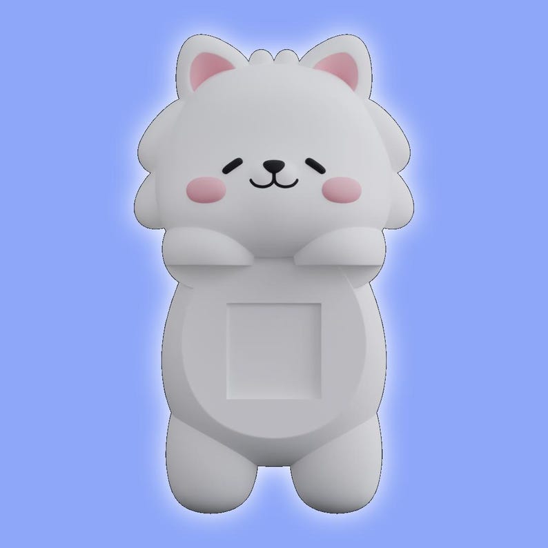 May include: A white, cartoon-style animal figurine with a rounded head, pointed ears with pink inner details, and pink circular cheeks. The figure has a small black nose and mouth, with a square-shaped cutout centered on its smooth, solid body.