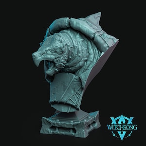 May include: A teal-colored resin bust of a reptilian creature with a textured, scaled head and open mouth, mounted on a rectangular base with rope-like detailing. The sculpture features the text WITCHSONG in the lower right corner of the frame.