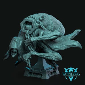 May include: A teal-colored resin figurine of a hunched, hooded creature carrying a large sack on its back, secured by a heavy chain and a hexagonal metal-like ring. The figure stands on a pedestal base with the text WITCHSONG printed in the corner.