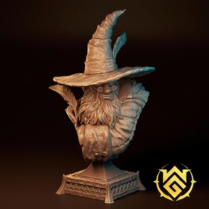 May include: A monochromatic resin bust of a bearded wizard wearing a tall, pointed hat and round spectacles. The figure holds a quill in one hand and is draped in textured robes. The bust rests on a square, ornate pedestal base with a geometric pattern.