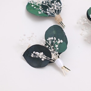 May include: A white ceramic mug with a black handle and the text "But First, Coffee" in a black, bold font. The mug is on a white surface. The mug is likely for hot beverages.