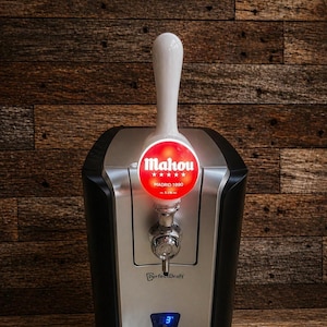 May include: A black and silver PerfectDraft beer dispenser with a white tap handle. The red illuminated logo reads "Mahou" and "Madrid 1890". A digital display shows the temperature.