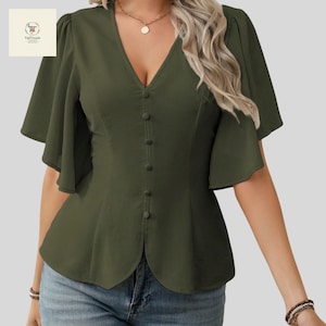 May include: Olive green blouse with a V-neckline and button-down front. The short sleeves have a flared design. The blouse has a fitted waist and a peplum hem. A gold necklace is visible. The blouse is paired with blue jeans.