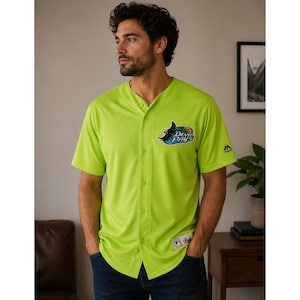 May include: A bright lime green short-sleeved button-down baseball jersey featuring a dark blue and teal Tampa Bay Devil Rays logo on the left chest. The jersey has a textured mesh fabric, a V-neckline, and a small Majestic brand logo on the sleeve.