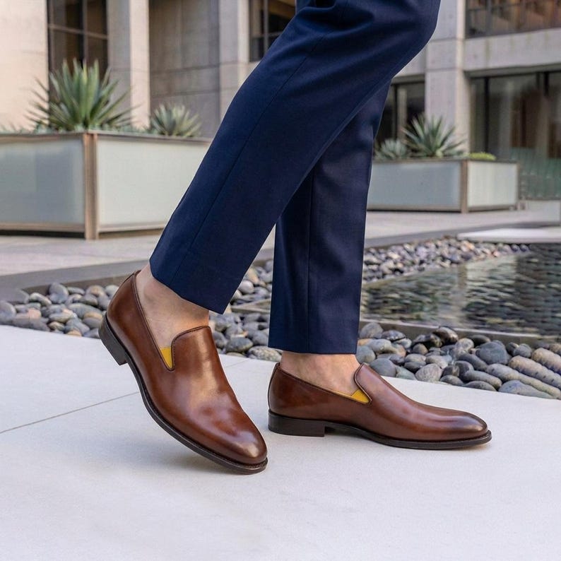 Genuine leather slip on shoes styled with navy dress pants
