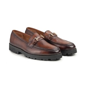 Top view of brown leather men's loafer showing gold metal horsebit hardware across the vamp