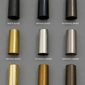 May include: A grid of nine cylindrical metal sleeves in various finishes: matte black, antique black, blackened brass, brushed brass, polished chrome, brushed chrome, polished brass, raw brass, and antique patina, each labeled with its finish name.
