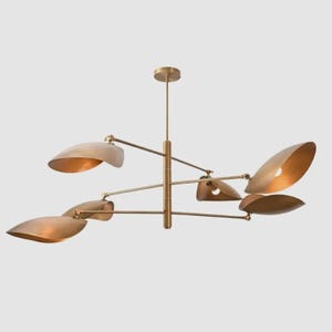 May include: A brass-toned chandelier featuring a central vertical rod with multiple horizontal arms extending outwards. Each arm supports a curved, leaf-shaped shade that directs light, creating a balanced and symmetrical lighting fixture.