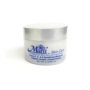 May include: A white jar of Marli Skin Care, with a silver lid. The label includes the brand name in a stylized script, along with text about the product's benefits and net weight of 2 oz / 56.7 g.