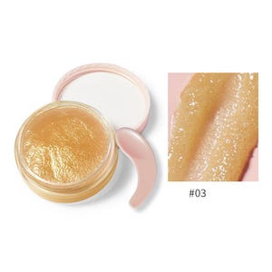 May include: A small, clear jar filled with a golden-colored lip scrub, with a pink lid and a matching applicator. The scrub is next to a smear of the product, and the number "#03" is visible.