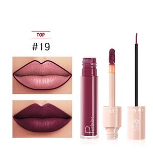 May include: A close-up of a lip gloss product with the text "TOP #19". The image shows a lip gloss tube, a lip liner, and two lip color swatches. The lip gloss is a deep burgundy color. The lip liner is a dark pink color.