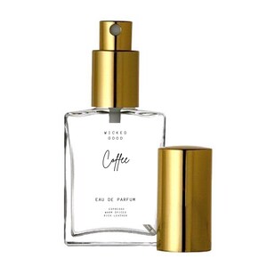 May include: A clear glass perfume bottle with a gold-colored cap and sprayer. The bottle has the words "Wicked Good Coffee" printed on the front, along with "Eau de Parfum" and scent notes: "Espresso, Warm Spices, Rich Leather."