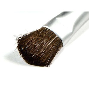 May include: Close-up of a makeup brush with a silver handle and dark brown bristles. The brush head is densely packed with fine bristles, and the handle has a smooth, metallic finish. The brush is angled slightly, showing the texture of the bristles.