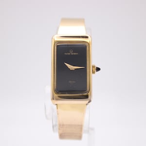 Michel Herbelin 2267 vintage ladies' rectangular gold tone manual wind watch with black dial, circa 1980s