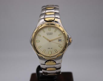 Citizen quartz 1112-S68334 tvåfärgad datumklocka med champagnefärgad urtavla – begagnad vintage herrarmbandsur