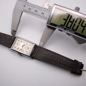 Digital caliper measuring the case width (excluding crown) of the PRONTO watch at 22.00mm, showing the brown leather strap.