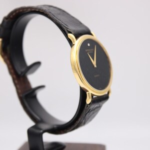 Another angled side view of the Raymond Weil watch, highlighting the profile of the gold case and crown.