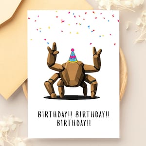 May include: A white greeting card featuring a brown, multi-legged rock creature wearing a colorful party hat with a pink pom-pom. The creature has its arms raised in a celebratory gesture amidst falling confetti. The text reads BIRTHDAY!! BIRTHDAY!! BIRTHDAY!!