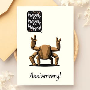 May include: A white greeting card featuring a brown, geometric, crab-like creature with raised claws. Above the creature is a black speech bubble with the text "Happy, Happy, Happy!" and below the creature is the text "Anniversary!" in black.
