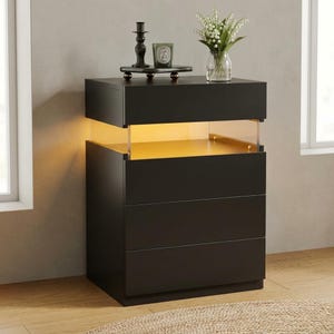 May include: A modern black nightstand with three drawers and a lighted shelf. The top surface holds a candle, a decorative tray, and a vase of white flowers. The nightstand is illuminated with a warm, inviting glow.