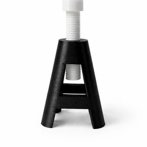 May include: A black, A-shaped stand with a white, threaded bolt. The stand has a wide base and tapers upwards, with a horizontal support bar. The bolt has a cylindrical head and is screwed into the stand.