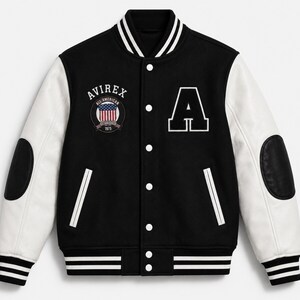 Front view of black and white AVIREX varsity jacket with embroidered patches and striped ribbed collar