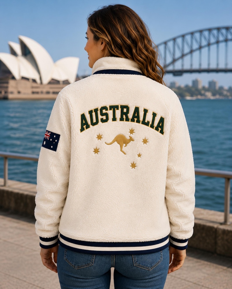 Women's Australia Sherpa Fleece Jacket back view with large AUSTRALIA lettering, kangaroo emblem, Southern Cross stars, cream Sherpa fleece and Australian flag patch on sleeve.