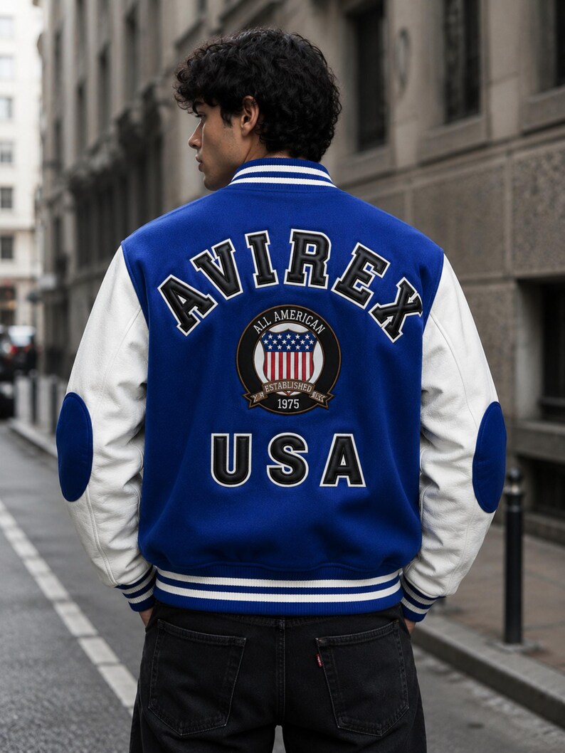 Back view of male model wearing AVIREX inspired varsity jacket with USA embroidery design”