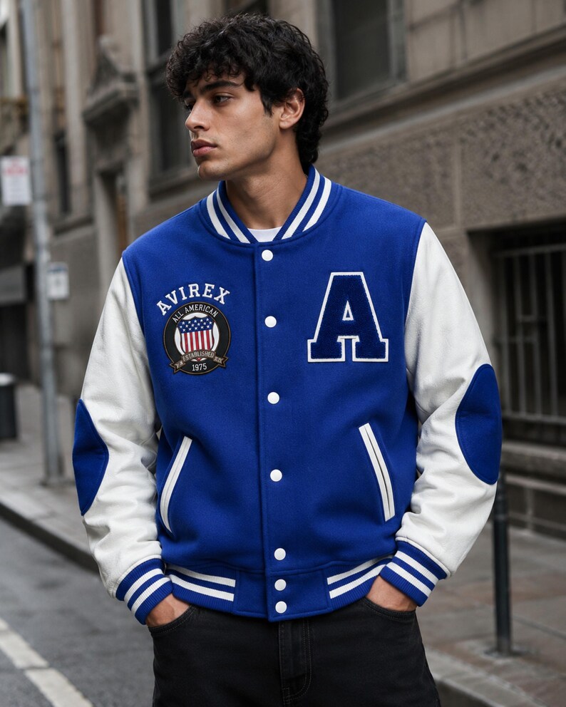 Men model styling premium blue varsity bomber jacket with white sleeves and street fashion look”