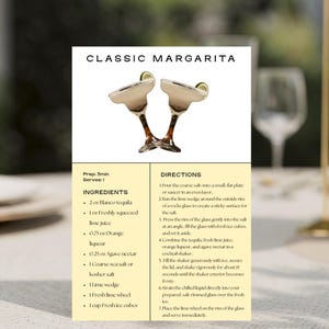 May include: A recipe card for a Classic Margarita cocktail, featuring a photo of two margarita glasses. The card includes ingredients like tequila, lime juice, and orange liqueur, along with preparation instructions. The card is on a table with glasses and floral arrangements.