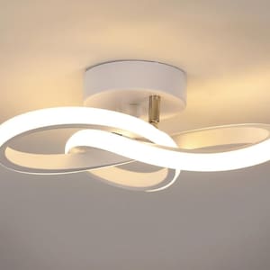 May include: A modern white ceiling light fixture with a unique, flowing design. The fixture features three interconnected, illuminated loops, creating a soft, ambient glow. The light is mounted on a white circular base.