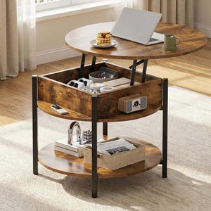 May include: A round, lift-top coffee table with a rustic wood finish and black metal frame. The table has a lower shelf and a hidden storage compartment. A laptop, mug, and snacks are on the tabletop. The table measures approximately 40 inches in diameter.