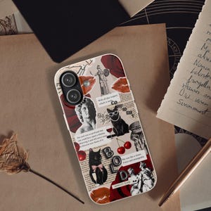 May include: A smartphone case featuring a collage of dark academia elements including classical statues, black cats, red roses, cherries, and printed text snippets. The design incorporates a mix of black, white, and deep red tones with a glossy finish.