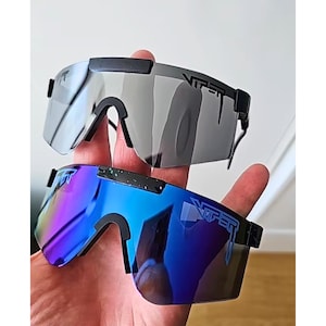 May include: Two pairs of Viper sunglasses. One pair has gray lenses, the other has blue and purple gradient lenses. Both have black frames and the Viper logo on the temples.