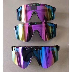 May include: Three pairs of iridescent sunglasses with a black frame and a mirrored lens. The lenses shift in color from purple to blue and yellow. The brand name is printed on the top of the frame in blue.