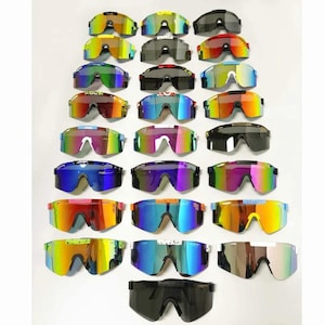 May include: A collection of colorful sports sunglasses with mirrored lenses. The sunglasses come in various colors, including yellow, green, blue, red, and black. The lenses have a reflective, iridescent finish. The frames are made of plastic.