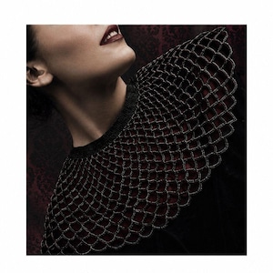 May include: A black crochet collar with a scale-like pattern, paired with a black top. The image features the text "The Christmas Witch shop" and "Crochet Patterns & Spooky Vibes". The model has dark lipstick and is looking up.