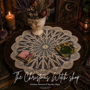 May include: A cream-colored, crocheted doily with a scalloped edge sits on a dark wooden tray, surrounded by candles, books, and a floral arrangement. A small, green ashtray and a decorative book are also present. The text "The Christmas Witch shop" is displayed.