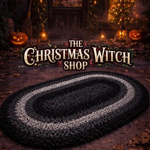 May include: An oval-shaped rug with a gradient design, transitioning from black to gray and back to black. The rug is displayed in front of a shop with the text "The Christmas Witch Shop". The scene includes pumpkins and Christmas trees.