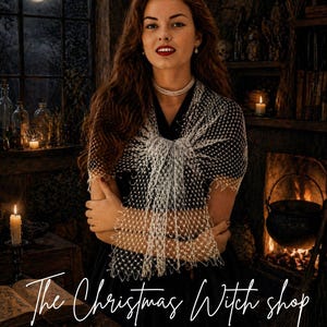 May include: A woman wearing a white crocheted shawl, with the text "Ghost Whisper Shawl" at the top. The image also includes the text "The Christmas Witch shop" and "Crochet Patterns & Spooky Vibes". The background features a fireplace and a full moon.