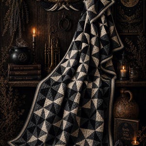 May include: A black, gray, and cream-colored quilt with a geometric triangle pattern is draped over a wooden shelf. The quilt is the focal point, with a dark, moody aesthetic. The shelf also holds books, candles, and a decorative eagle.
