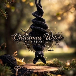 May include: A black crocheted bat decoration hangs from a branch. The bat is suspended upside down, with a spiral body and a head featuring white cross-shaped eyes. The image includes the text "Christmas Witch Shop" and "Crochet Patterns & Spooky Vibes".