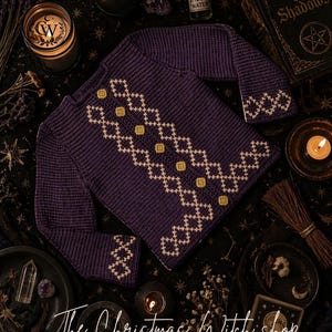 May include: A dark purple Midnight Amethyst cardigan with a cream-colored geometric design and matching buttons. The text "Midnight Amethyst Cardigan" is at the top. The bottom of the image has the text "The Christmas Witch Shop".