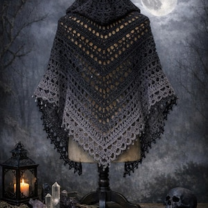 May include: A dark gray crocheted shawl with a hood, displayed on a mannequin. The shawl features a gradient effect, transitioning from dark gray to lighter gray. The image includes the text "Shadow Veil Shawl" and "Crochet Pattern PDF".