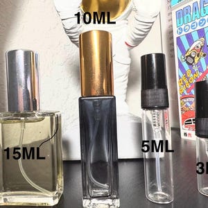 May include: Four perfume bottles of varying sizes: 15ml, 10ml, 5ml, and 3ml. The 15ml bottle is square with a silver cap. The 10ml bottle is rectangular with a gold cap. The 5ml and 3ml bottles are clear with black caps. The bottles are for fragrance samples.