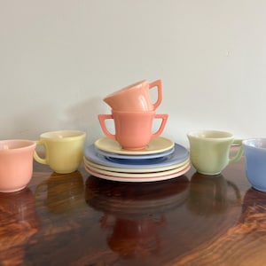 May include: A set of three ceramic mugs with a speckled, matte finish. The mugs are in shades of cream, light gray, and dark gray. Each mug has a simple, minimalist design, perfect for coffee or tea.