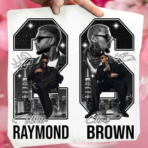 May include: A white t-shirt featuring a graphic design with two large black numbers 2 and 6. Inside the numbers are black and white portraits of Usher and Chris Brown, city skylines, and star-filled skies. The names Usher Raymond and Chris Brown are printed below.