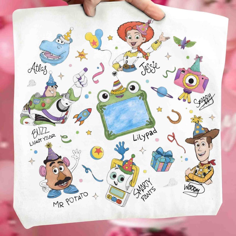 May include: A white fabric surface featuring colorful cartoon illustrations of characters including Buzz Lightyear, Jessie, Woody, Mr. Potato Head, and a frog-shaped frame labeled Lilypad, along with party-themed icons and text labels.