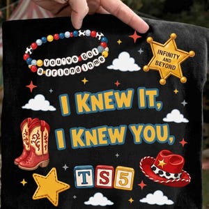 May include: A black t-shirt featuring a graphic print with the text "I KNEW IT, I KNEW YOU," a beaded bracelet with "YOU'VE GOT A FRIEND IN ME," a gold sheriff badge with "INFINITY AND BEYOND," red cowboy boots, a red cowboy hat, and "TS5" blocks.
